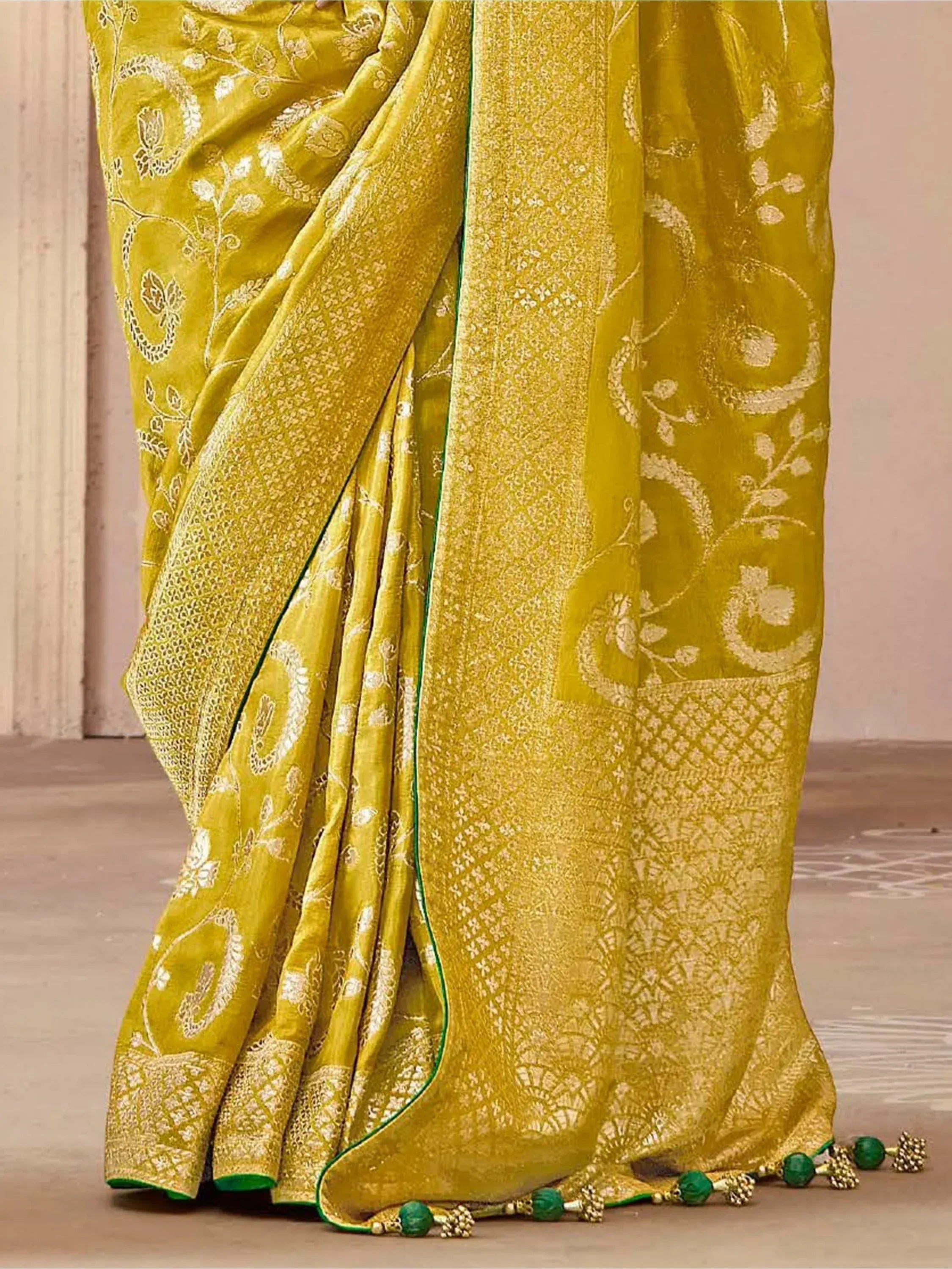 Mustard yellow designer saree with gold floral embroidery and green tassels, ethnic wear