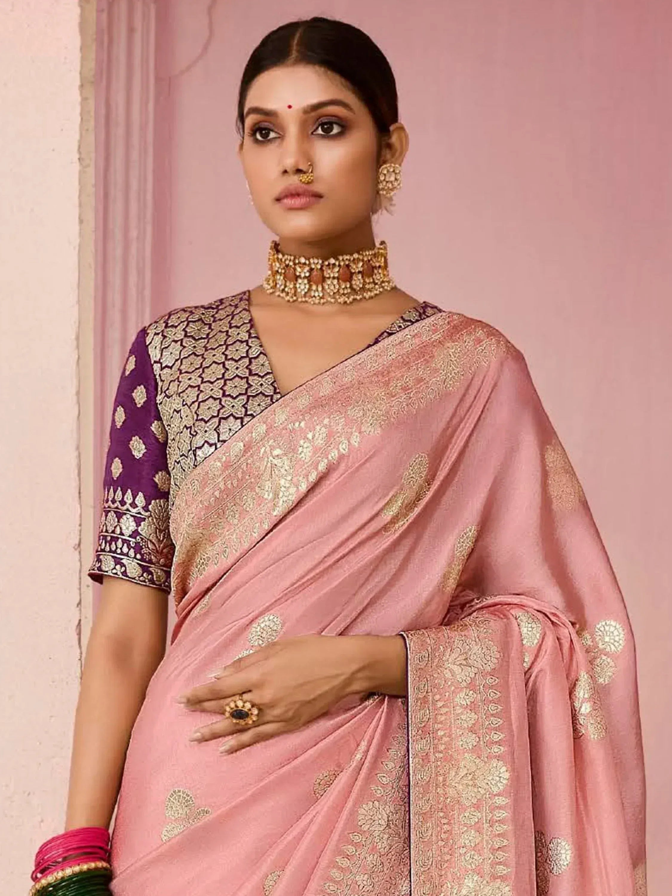 Pink embroidered saree with purple blouse, gold jewelry, perfect for Indian ethnic wear occasions