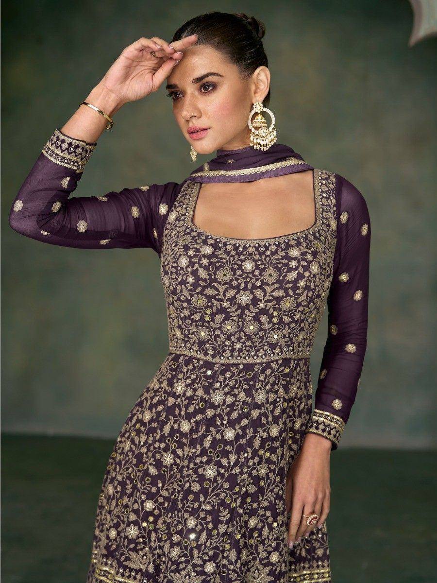 Purple embroidered ethnic gown with gold floral work and matching dupatta, perfect for Indian occasions.
