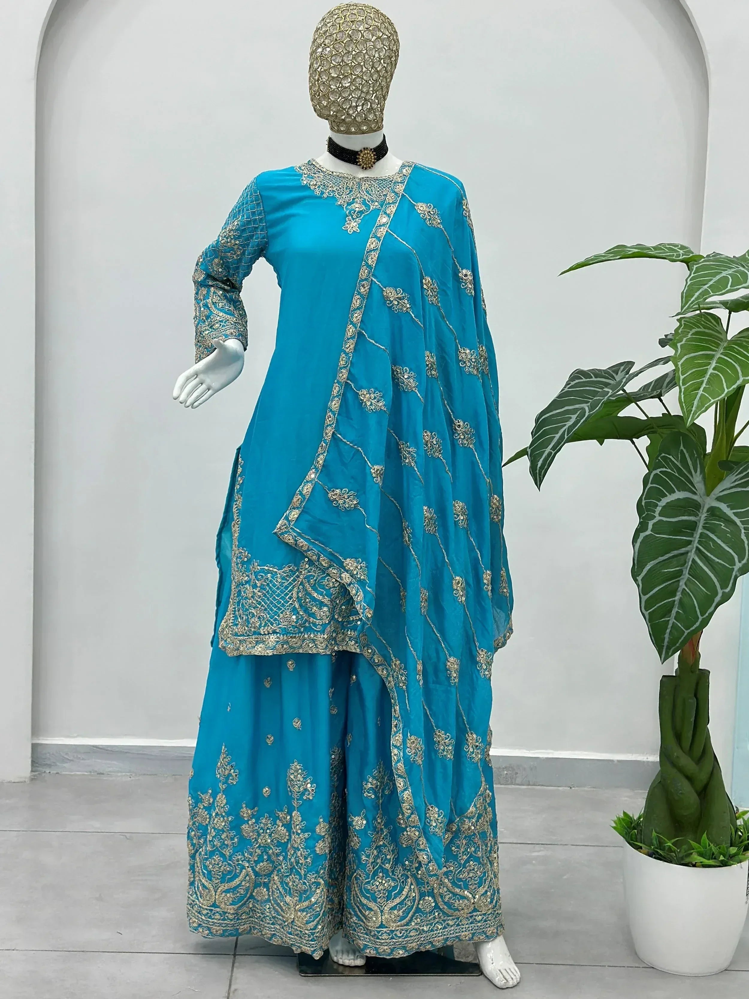 Turquoise Indian ethnic wear with gold embroidery, featuring a designer salwar kameez set for women.