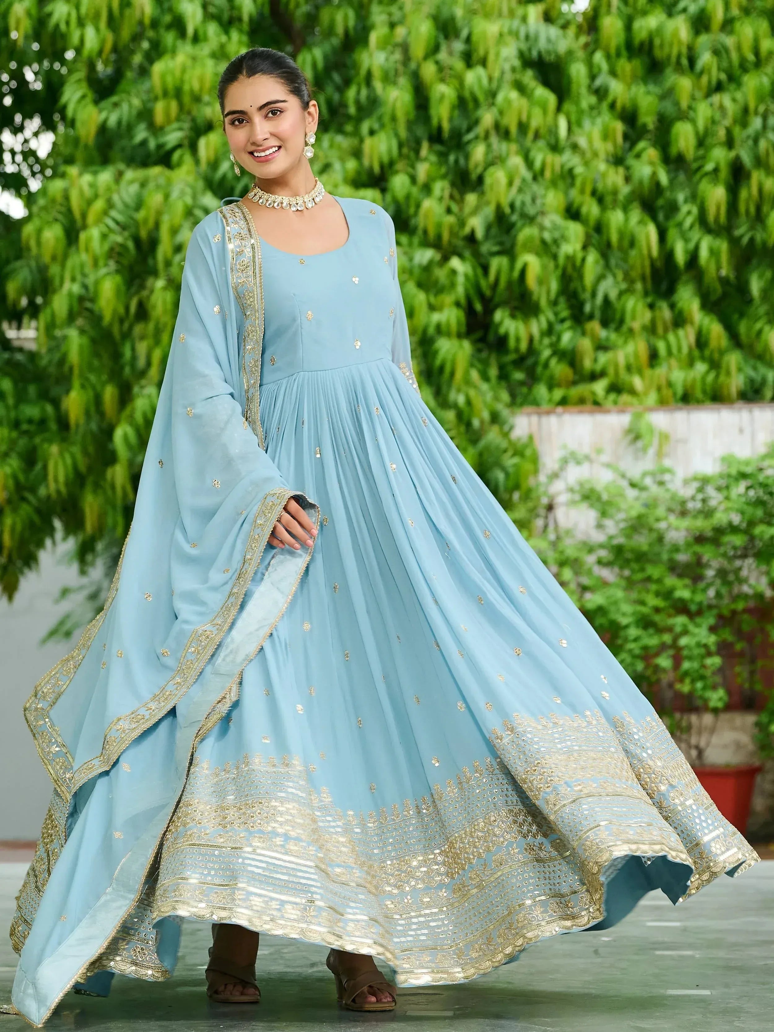 Light blue ethnic gown with gold embroidery, perfect for Indian festive occasions