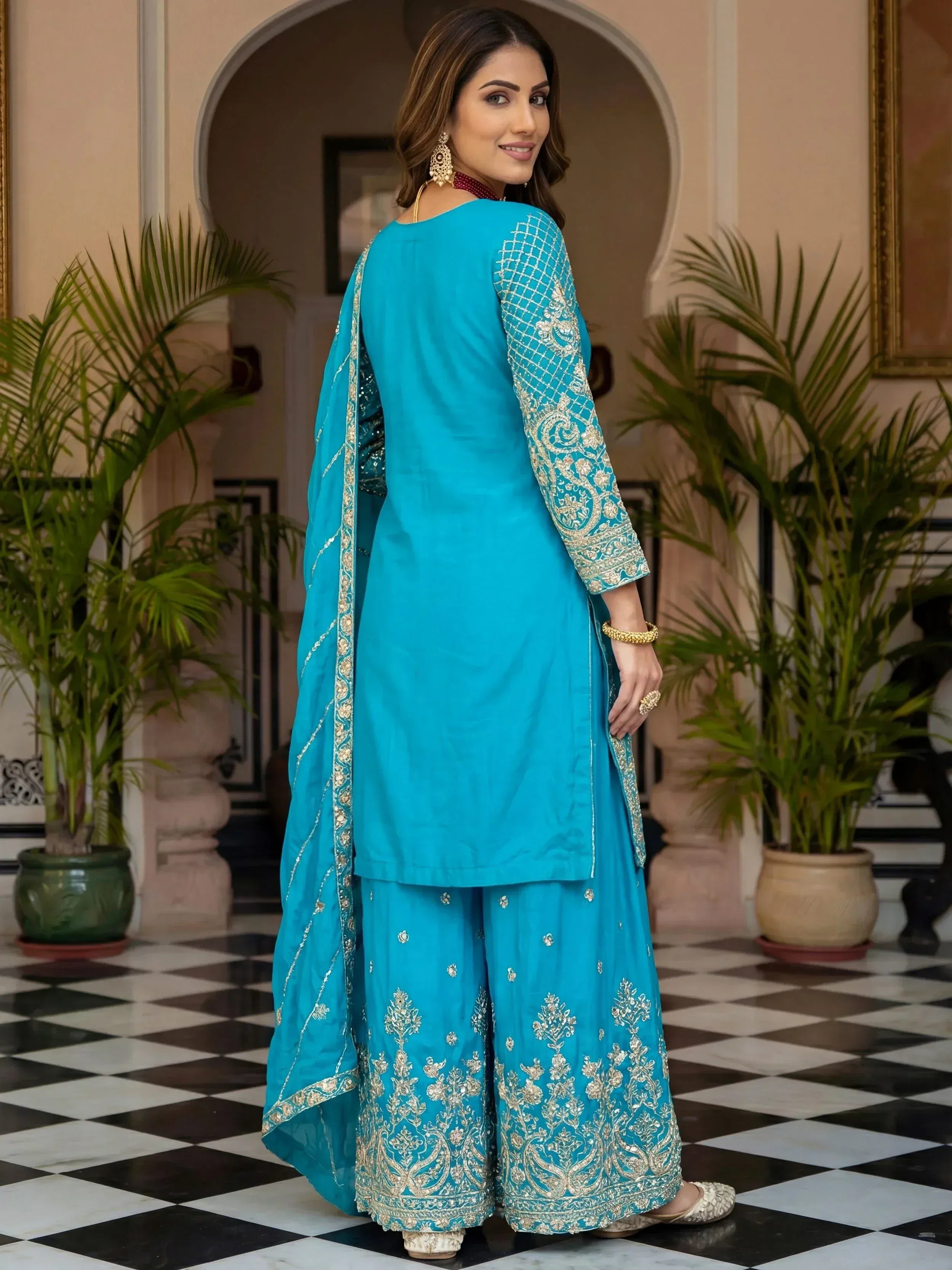 Turquoise embroidered salwar kameez with gold detailing, perfect for Indian ethnic wear occasions