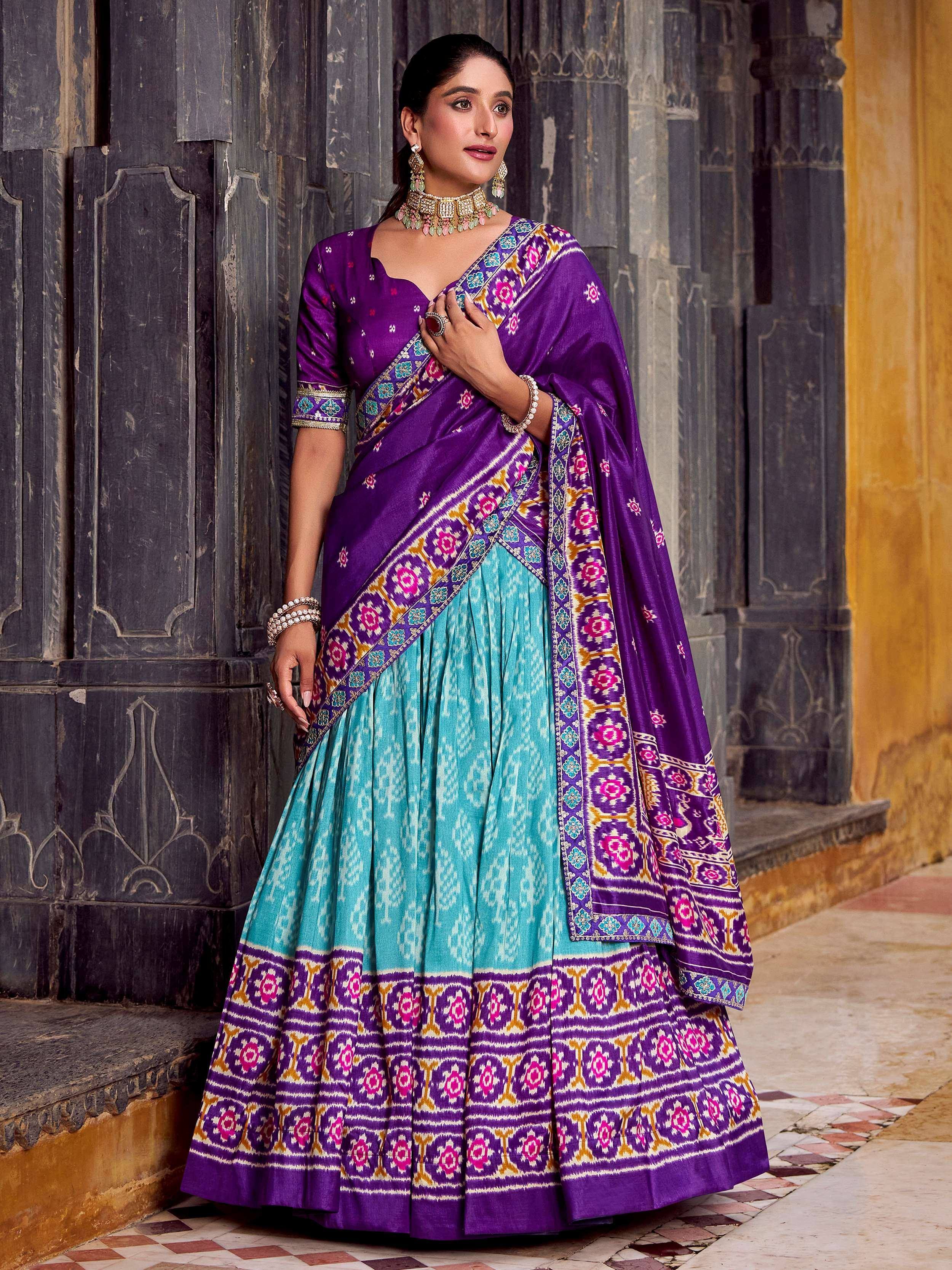 Purple and turquoise designer lehenga choli with intricate floral embroidery, perfect for Indian ethnic wear occasions.