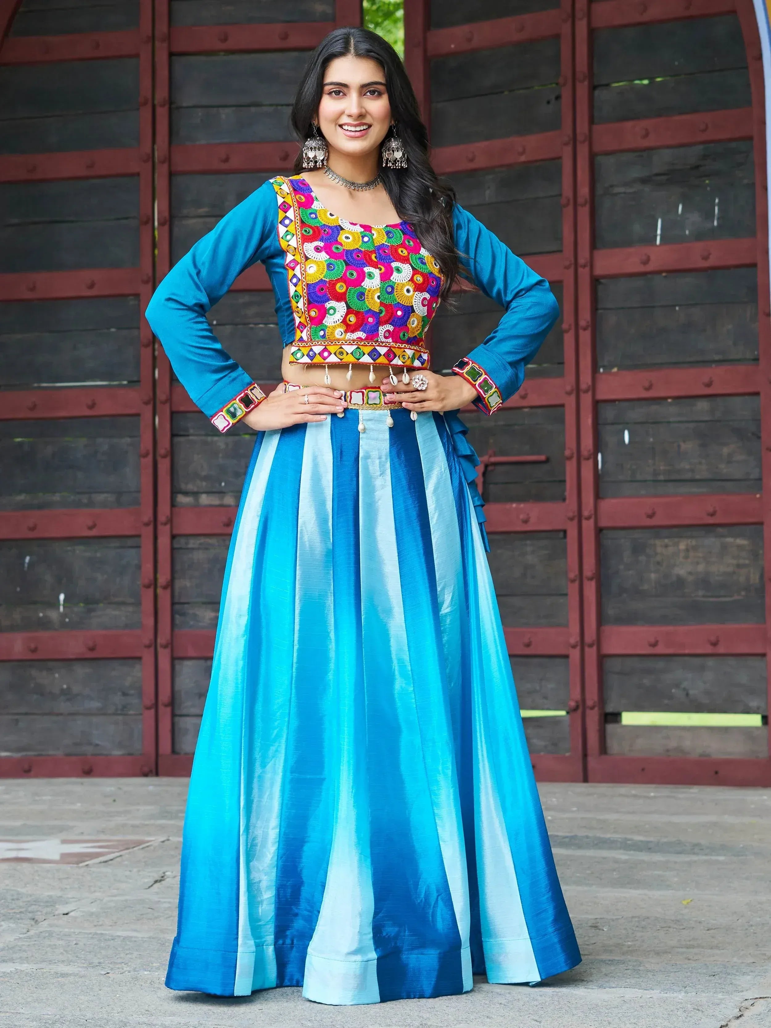 Blue ethnic lehenga choli with colorful mirror work and striped skirt, perfect for festive occasions