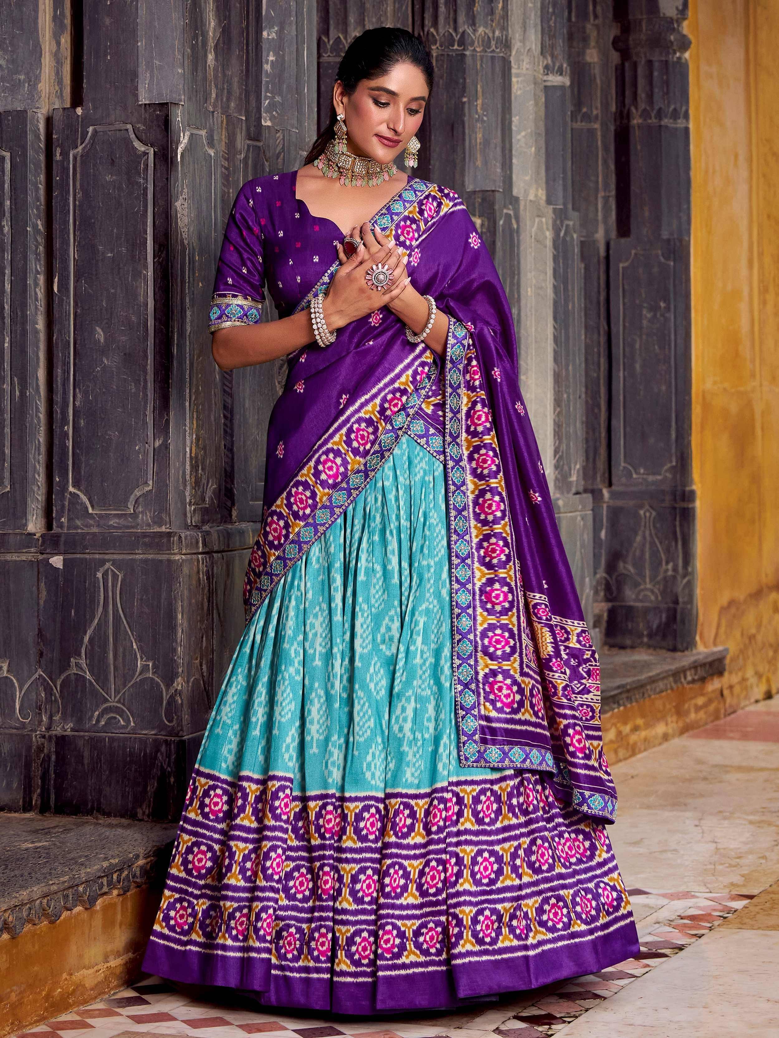 Purple and turquoise designer lehenga choli with intricate floral embroidery, perfect for Indian ethnic wear occasions.