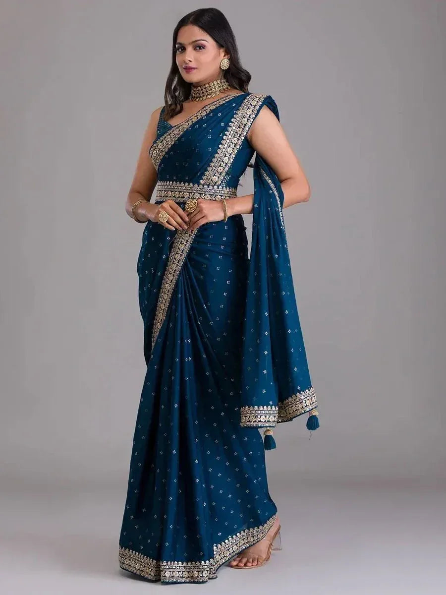 Elegant teal saree with gold embroidery and tassels, perfect for Indian ethnic wear occasions