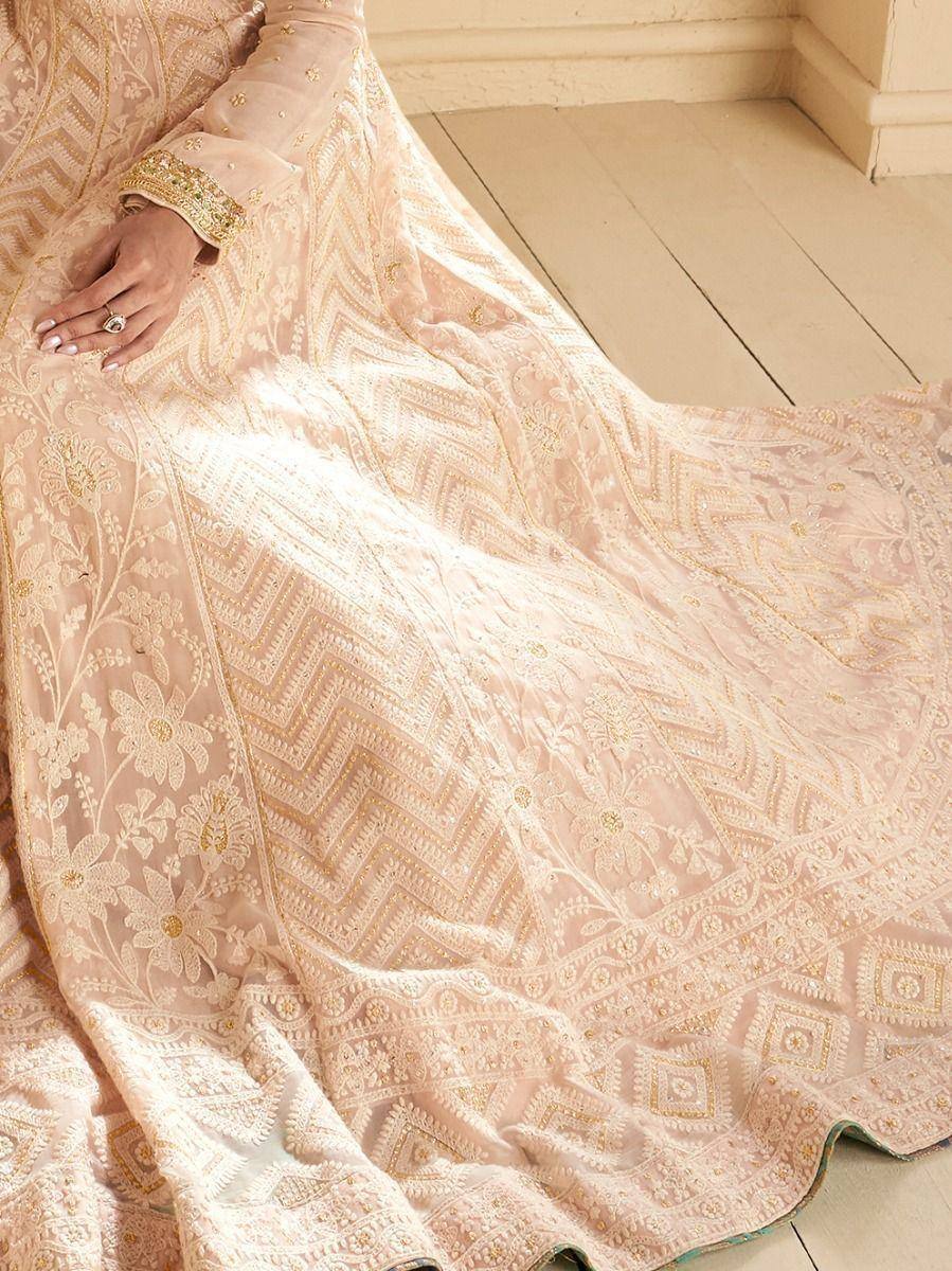 Elegant blush pink lehenga with gold floral and geometric embroidery, perfect for Indian ethnic wear occasions.