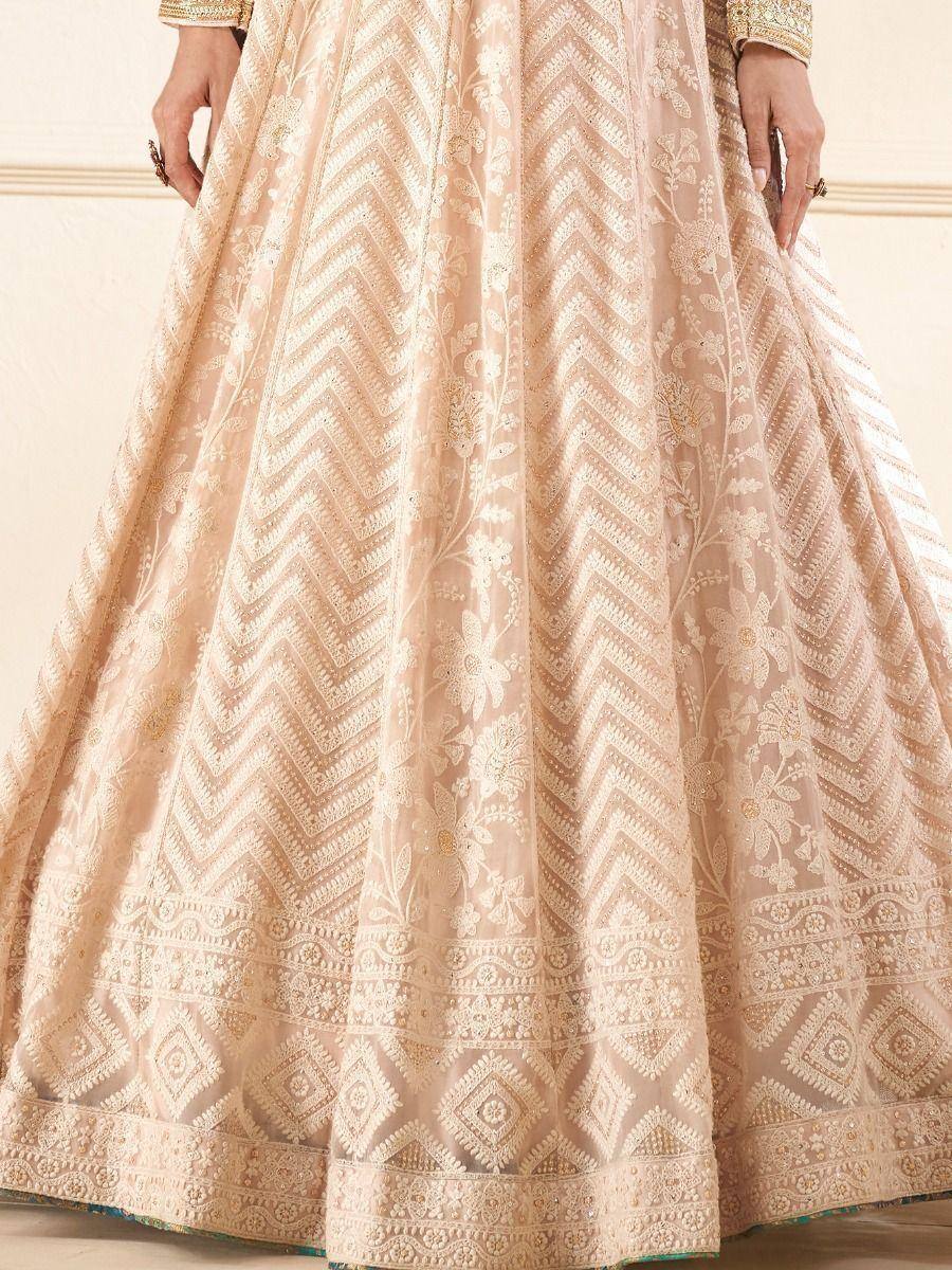 Elegant beige lehenga with intricate floral and chevron embroidery, perfect for Indian ethnic wear.