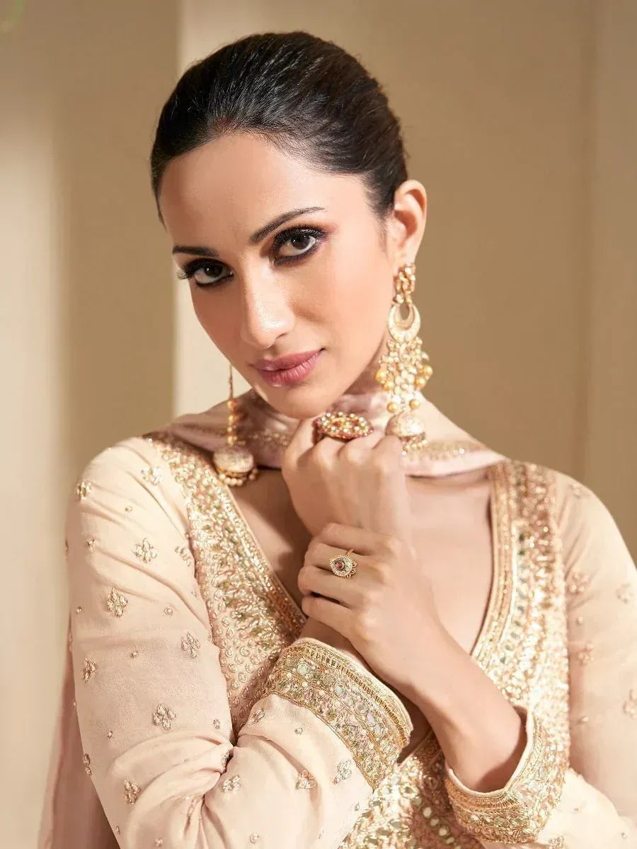 Elegant woman in designer ethnic wear with gold embroidery and traditional jewelry