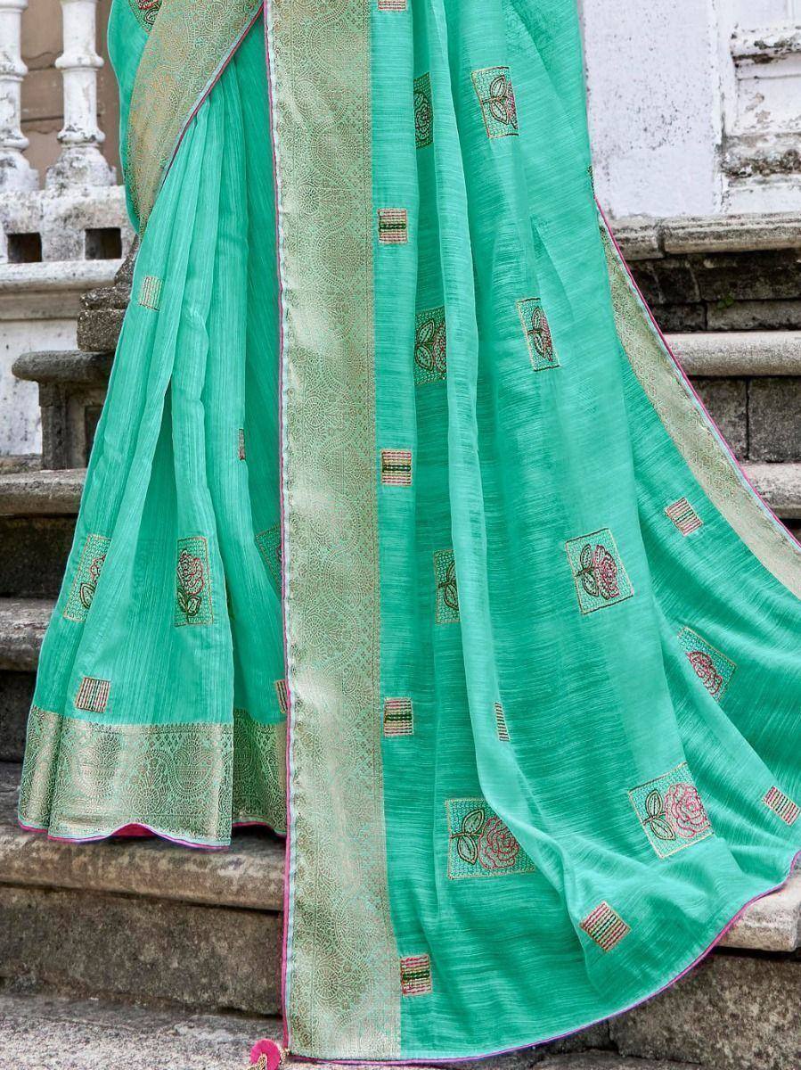 Mint green embroidered saree with floral motifs and golden border, ideal for ethnic occasions