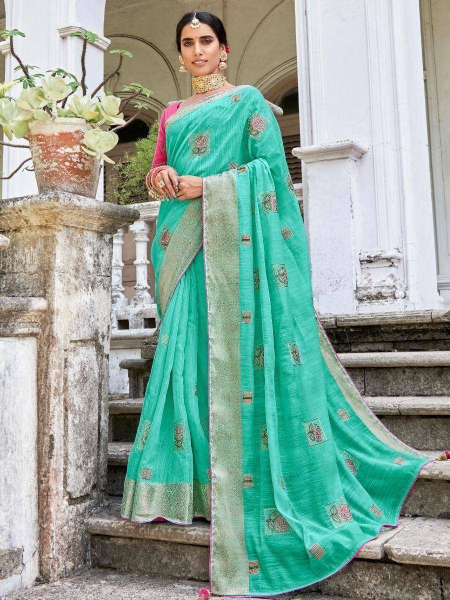 Emerald green embroidered saree with gold border, worn with pink blouse, perfect for Indian ethnic occasions