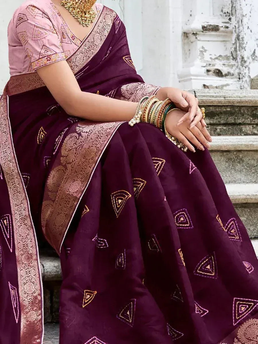 Elegant maroon saree with gold embroidery and pink blouse, styled with traditional jewelry