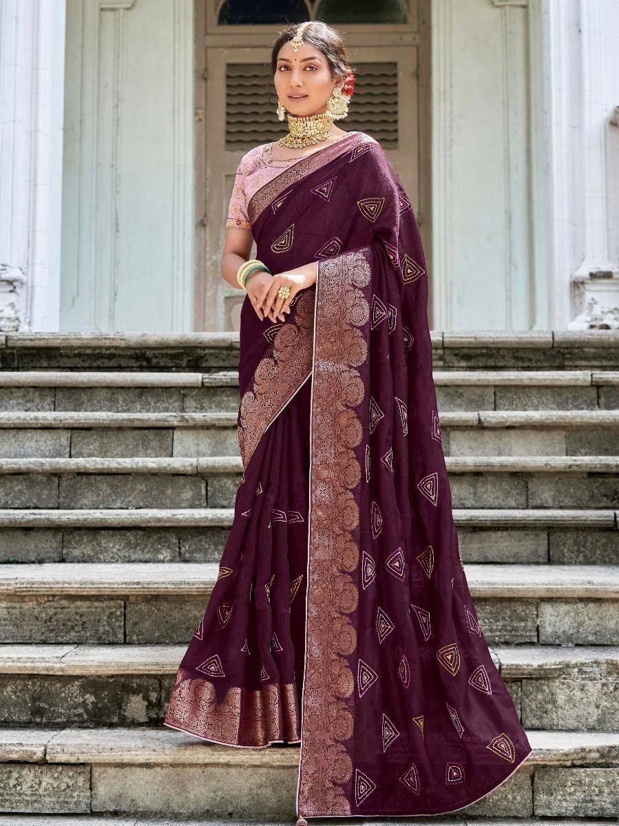 Elegant maroon saree with gold geometric prints and heavy border, paired with pink blouse for Indian ethnic wear