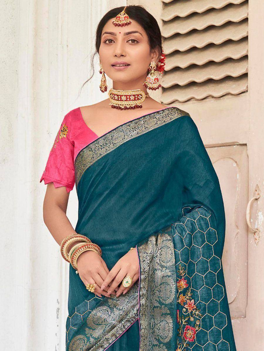 Teal embroidered saree with pink blouse, gold border, and floral motifs for Indian ethnic wear