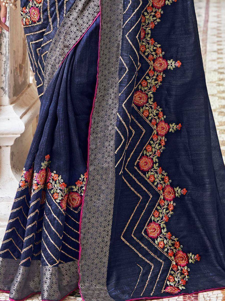 Navy blue embroidered saree with floral motifs and gold zigzag border, ideal for ethnic occasions