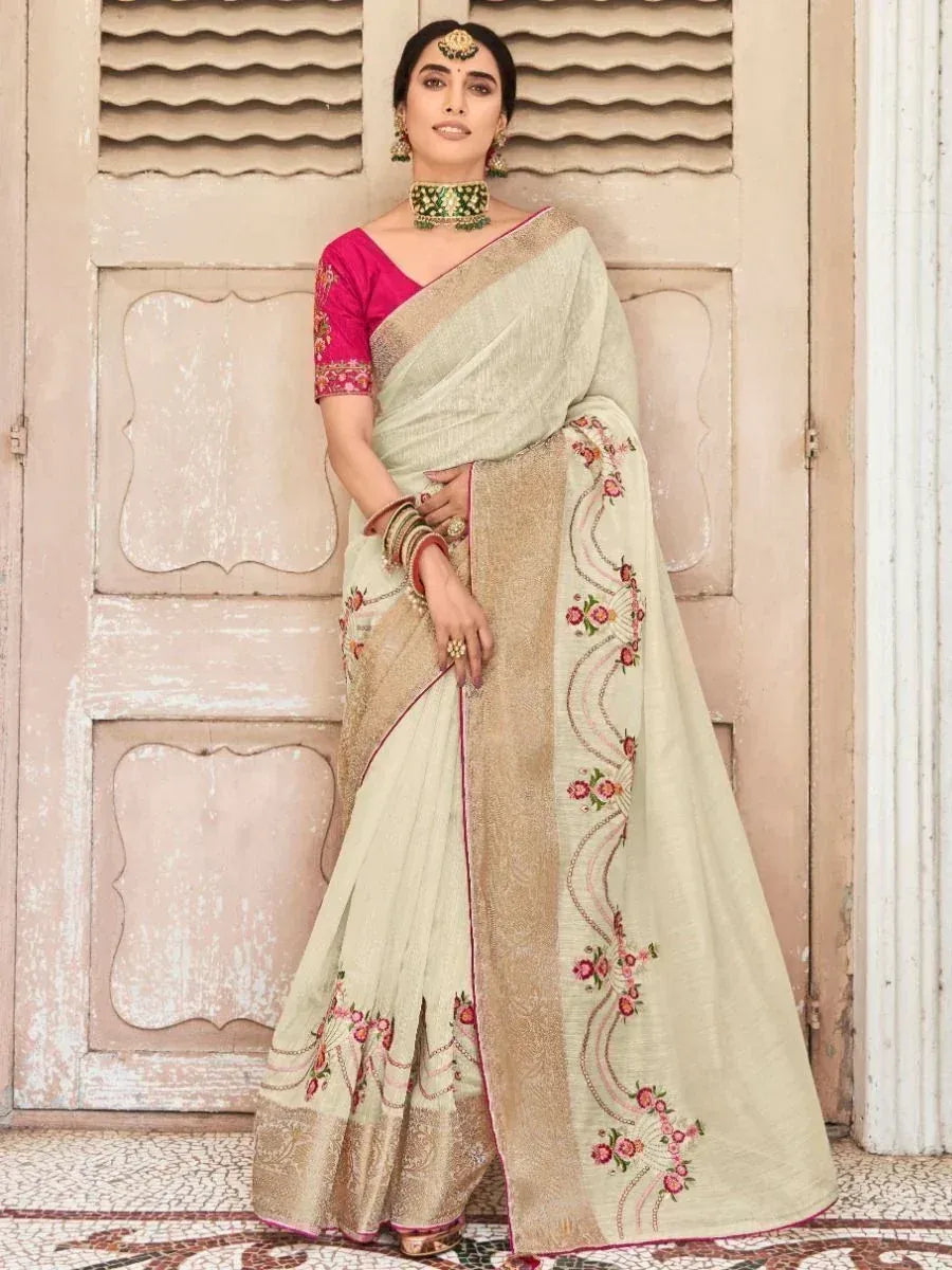 Elegant cream saree with pink floral embroidery and gold border, paired with pink blouse, perfect for Indian ethnic wear.