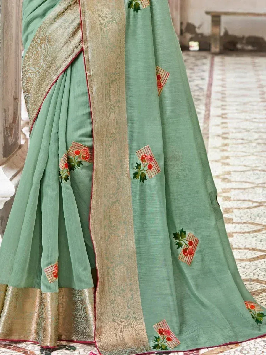 Mint green designer saree with floral embroidery and gold border, perfect for ethnic occasions