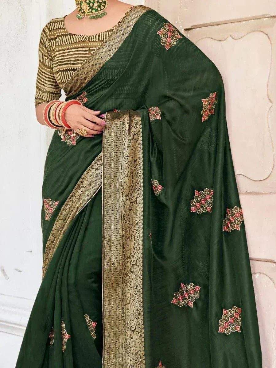 Emerald green saree with gold border and red floral embroidery, paired with striped blouse for Indian ethnic wear
