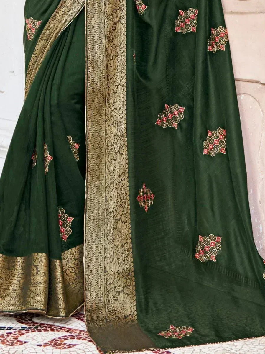 Dark green ethnic saree with gold border and red-gold embroidery, perfect for Indian occasions.
