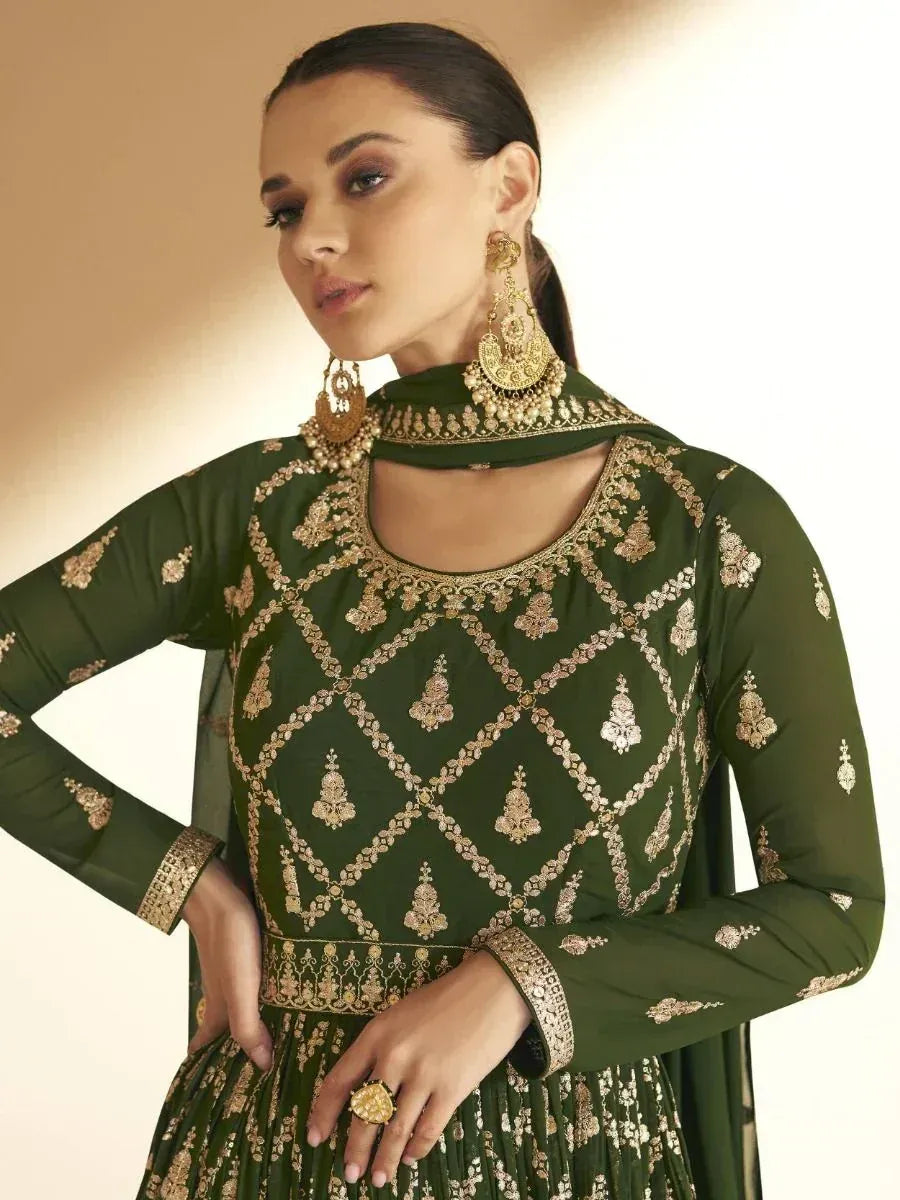 Green embroidered ethnic gown with gold detailing, perfect for Indian festive occasions