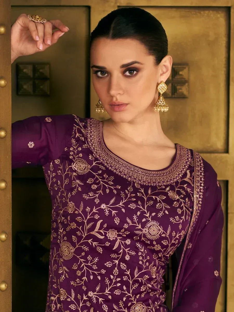 Purple embroidered ethnic kurti with gold floral detailing, paired with jhumka earrings for traditional Indian wear