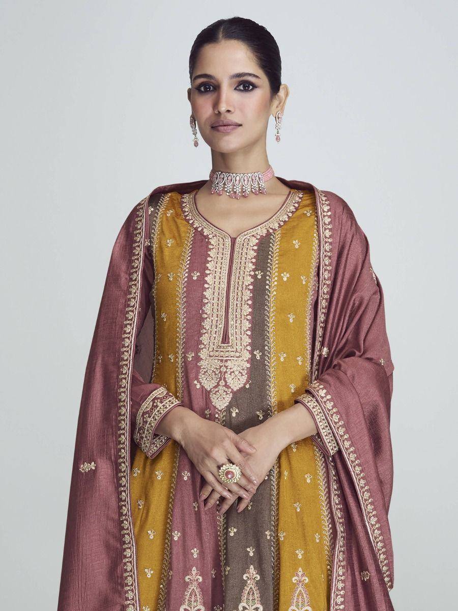 Elegant Indian ethnic wear with gold embroidery, maroon dupatta, and traditional jewelry for festive occasions