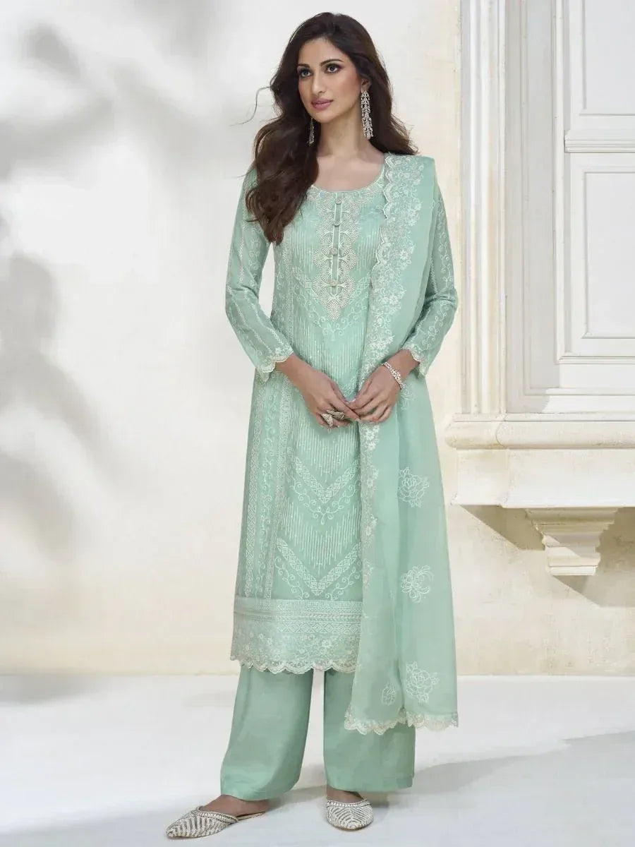 Mint green embroidered salwar kameez with lace detailing, perfect for Indian ethnic wear occasions.