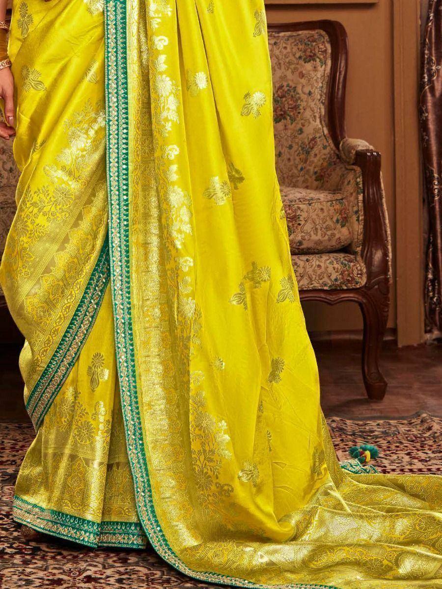 Vibrant yellow designer saree with gold floral embroidery and green border, perfect for ethnic occasions