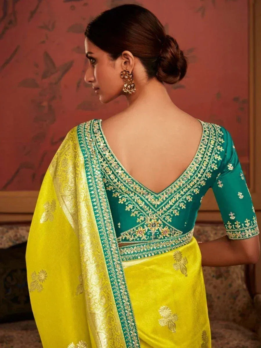 Yellow and green designer saree with intricate embroidery and backless blouse, perfect for ethnic occasions