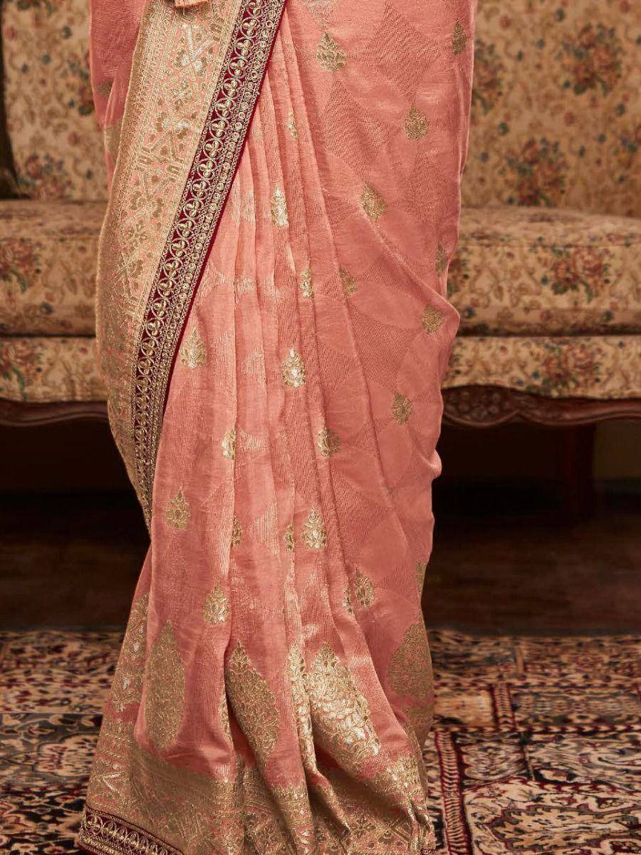 Pink ethnic saree with gold floral embroidery and intricate border, perfect for Indian occasions
