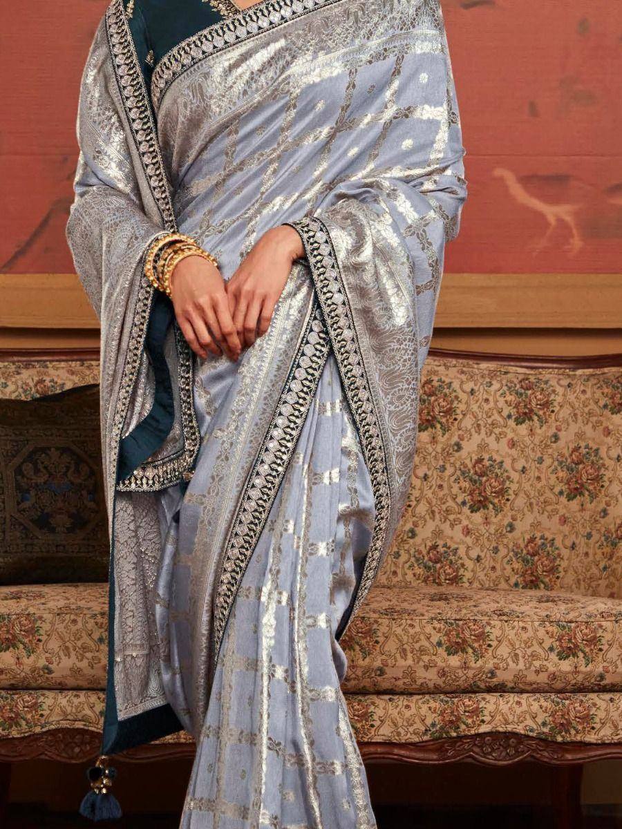 Elegant light blue saree with silver zari work and dark blue blouse, perfect for Indian ethnic occasions