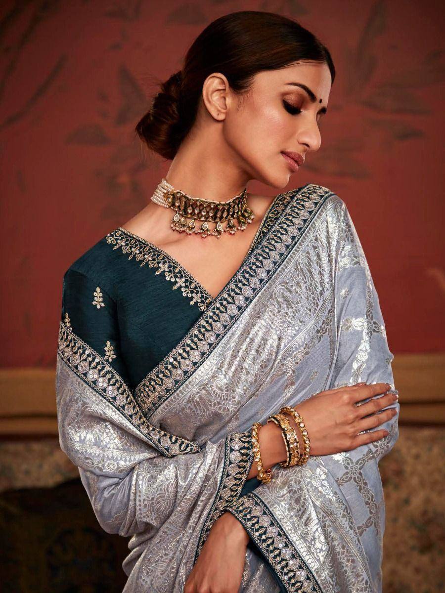 Elegant silver and teal embroidered saree with matching blouse, perfect for Indian ethnic occasions.