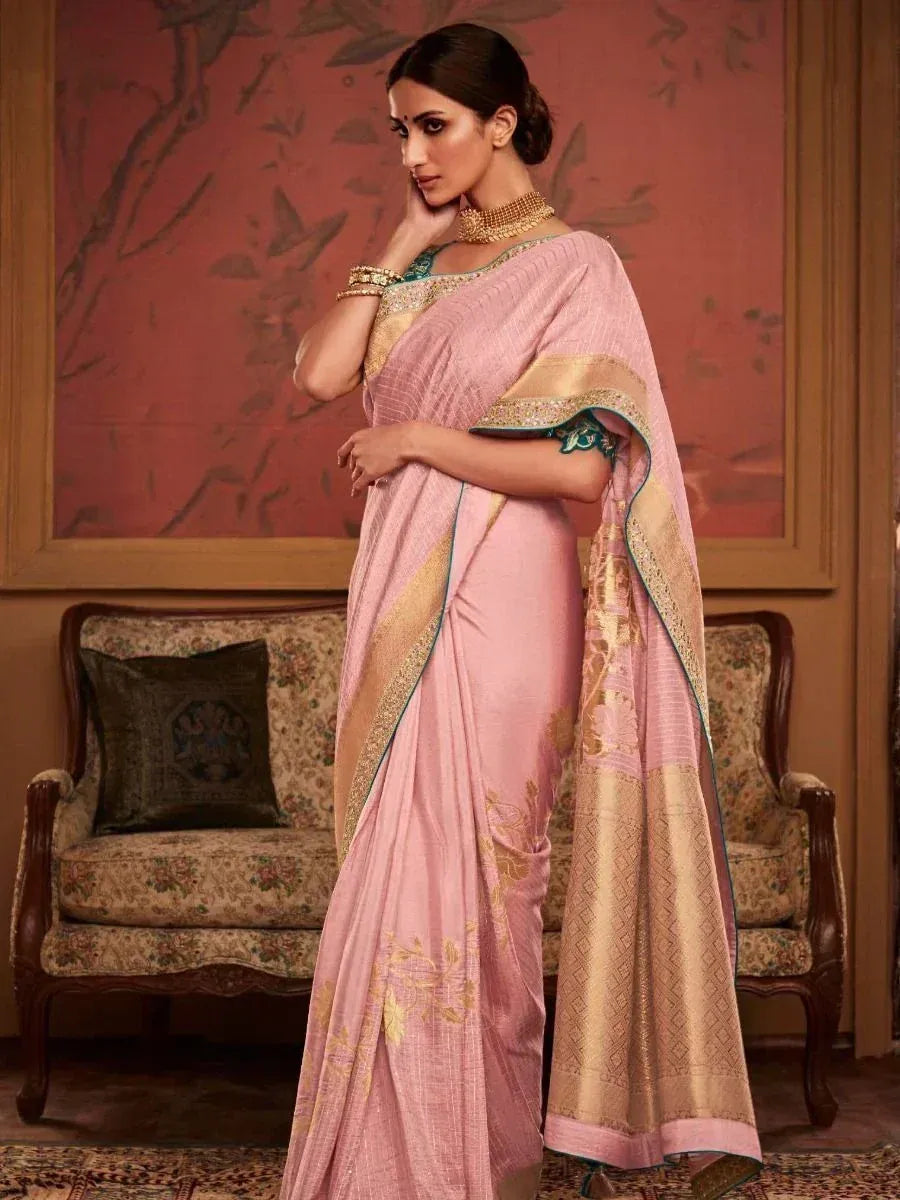 Elegant pink saree with gold border and floral embroidery, styled with traditional jewelry for festive occasions