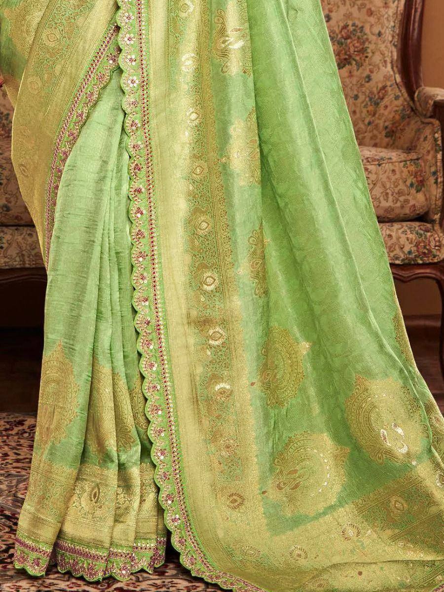 Light green ethnic saree with gold paisley print and scalloped border, perfect for Indian occasions