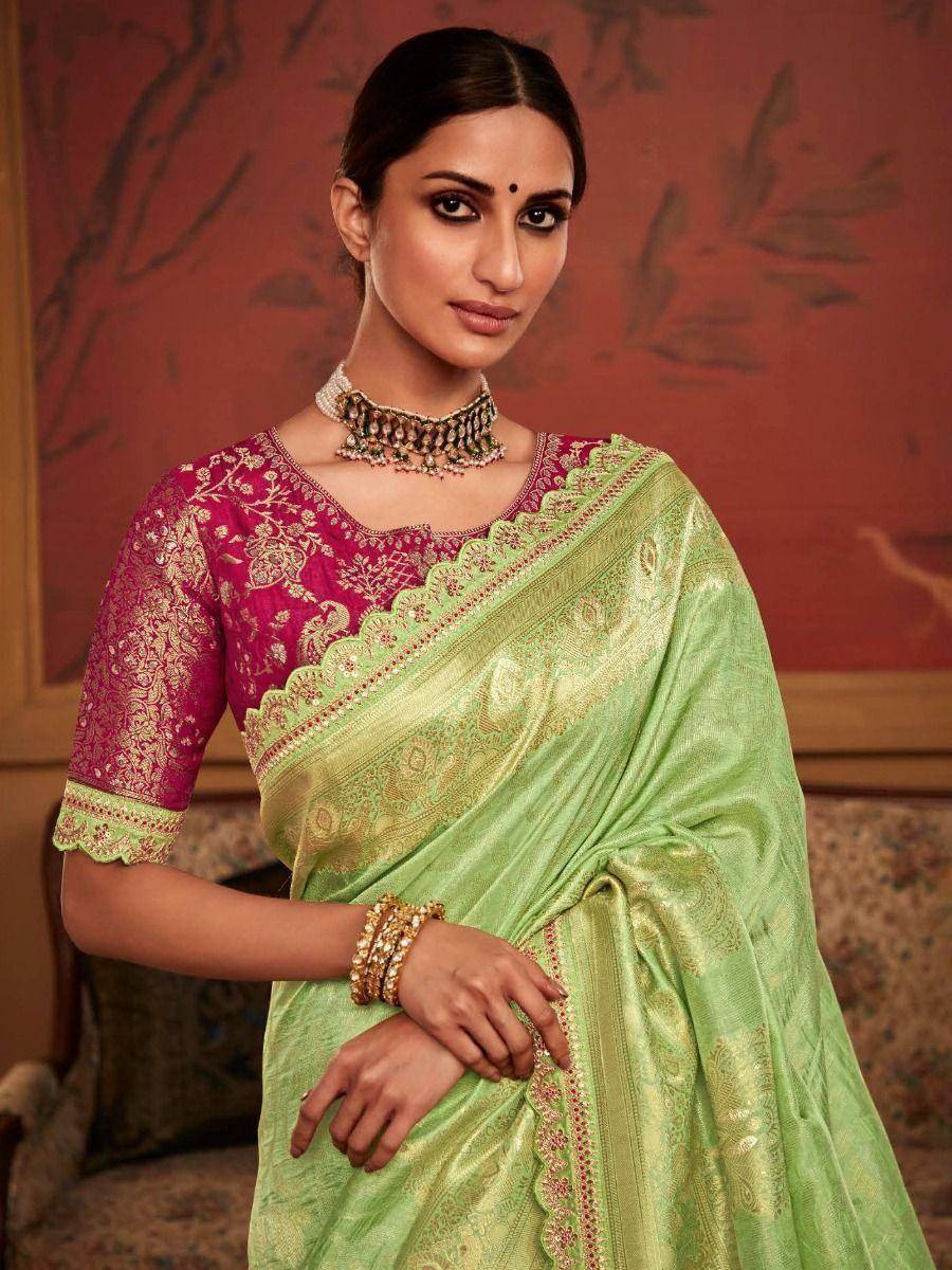 Elegant green silk saree with gold zari work and pink embroidered blouse, perfect for Indian ethnic occasions