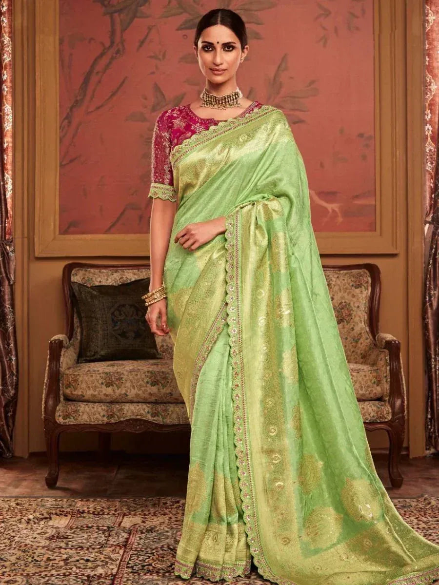 Elegant green saree with gold embroidery and pink blouse, perfect for Indian ethnic wear occasions.