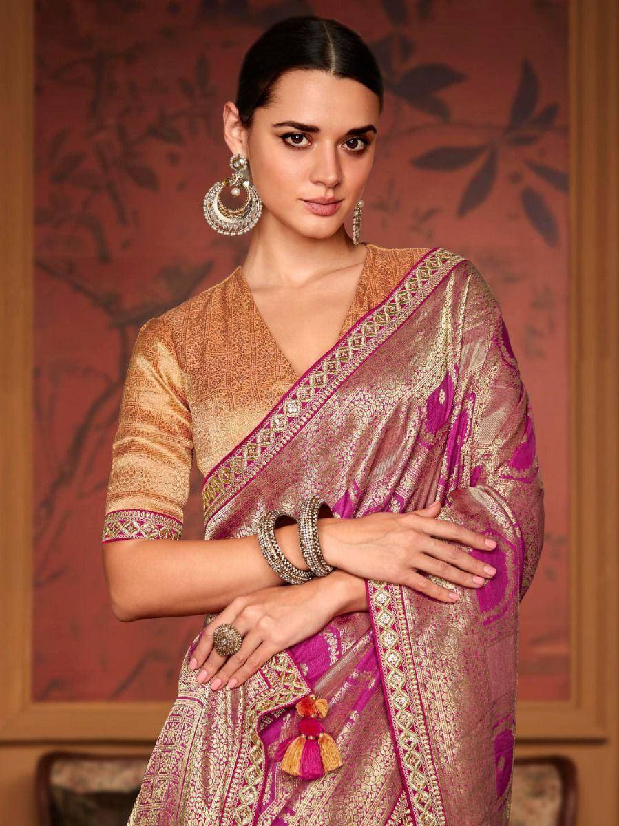 Elegant pink and gold designer saree with intricate embroidery, paired with matching blouse and traditional jewelry