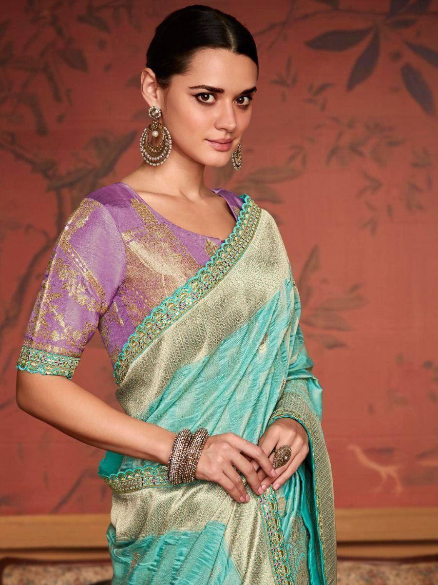 Elegant turquoise and gold saree with purple blouse, perfect for Indian ethnic wear occasions