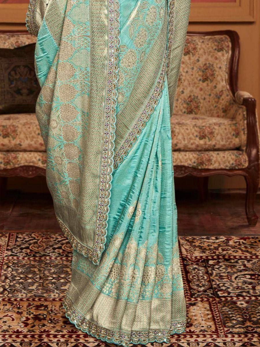 Turquoise designer saree with gold embroidery and scalloped border, perfect for ethnic occasions
