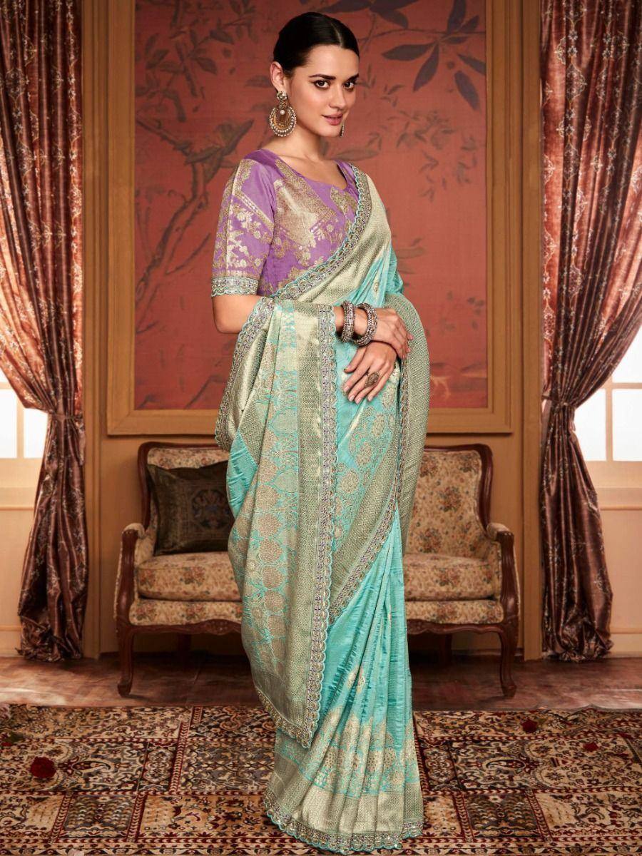 Elegant turquoise and purple designer saree with gold embroidery, perfect for Indian ethnic occasions.