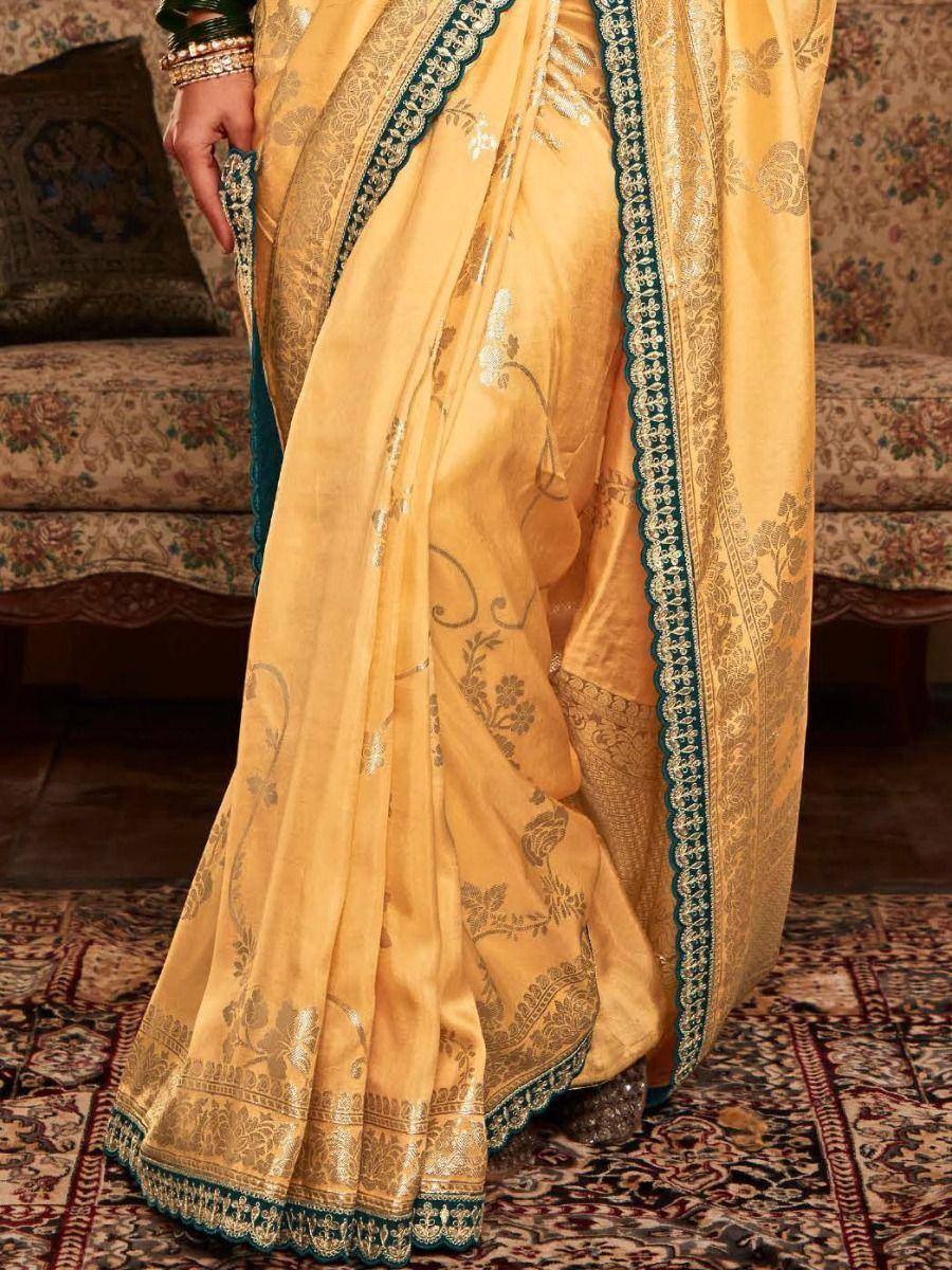 Yellow designer saree with gold floral embroidery and teal border, ethnic wear for women