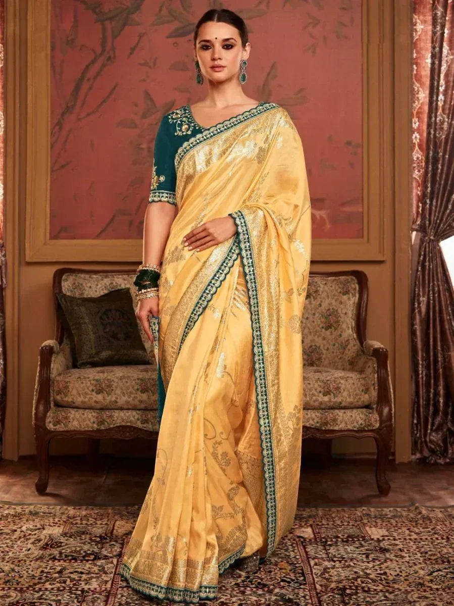 Yellow designer saree with green border and embroidery, paired with matching blouse for ethnic wear