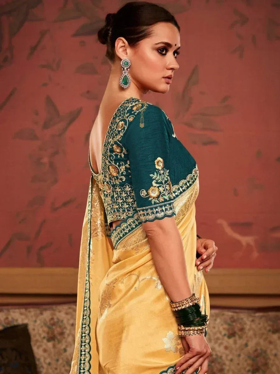 Elegant yellow saree with teal embroidered blouse, perfect for Indian ethnic occasions