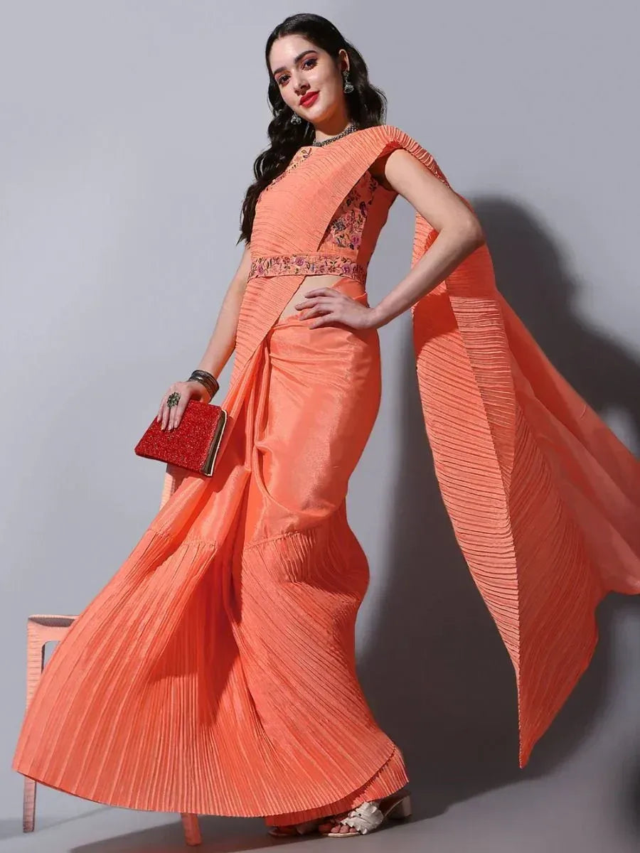 Orange pleated saree with floral blouse, perfect for Indian ethnic wear occasions