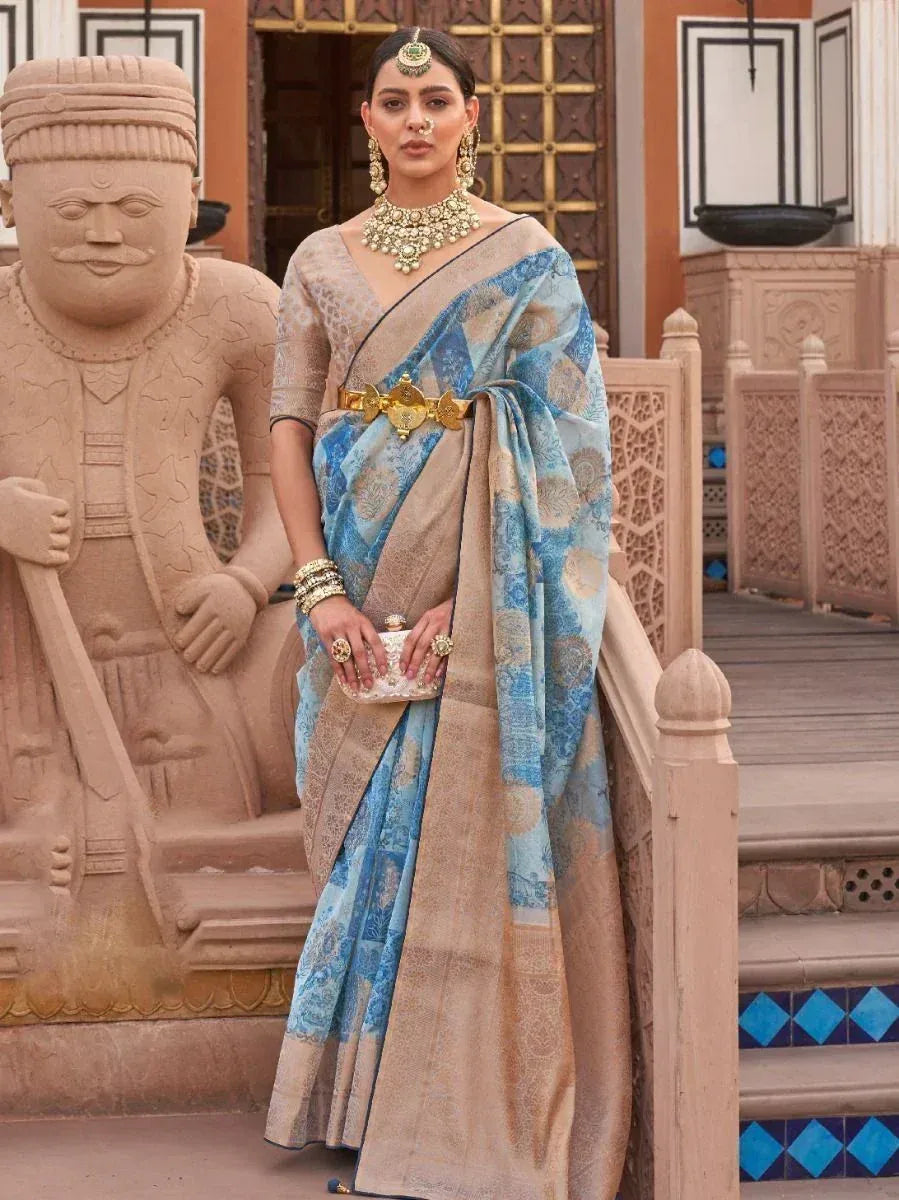 Woman in elegant blue and beige designer saree with gold jewelry, perfect for Indian ethnic occasions