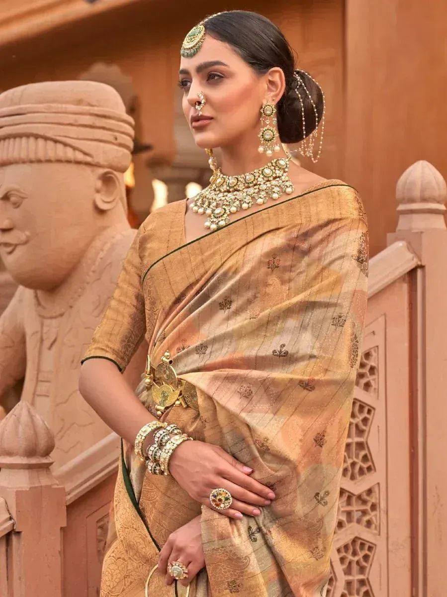 Elegant woman in golden ethnic saree with intricate jewelry, traditional Indian attire