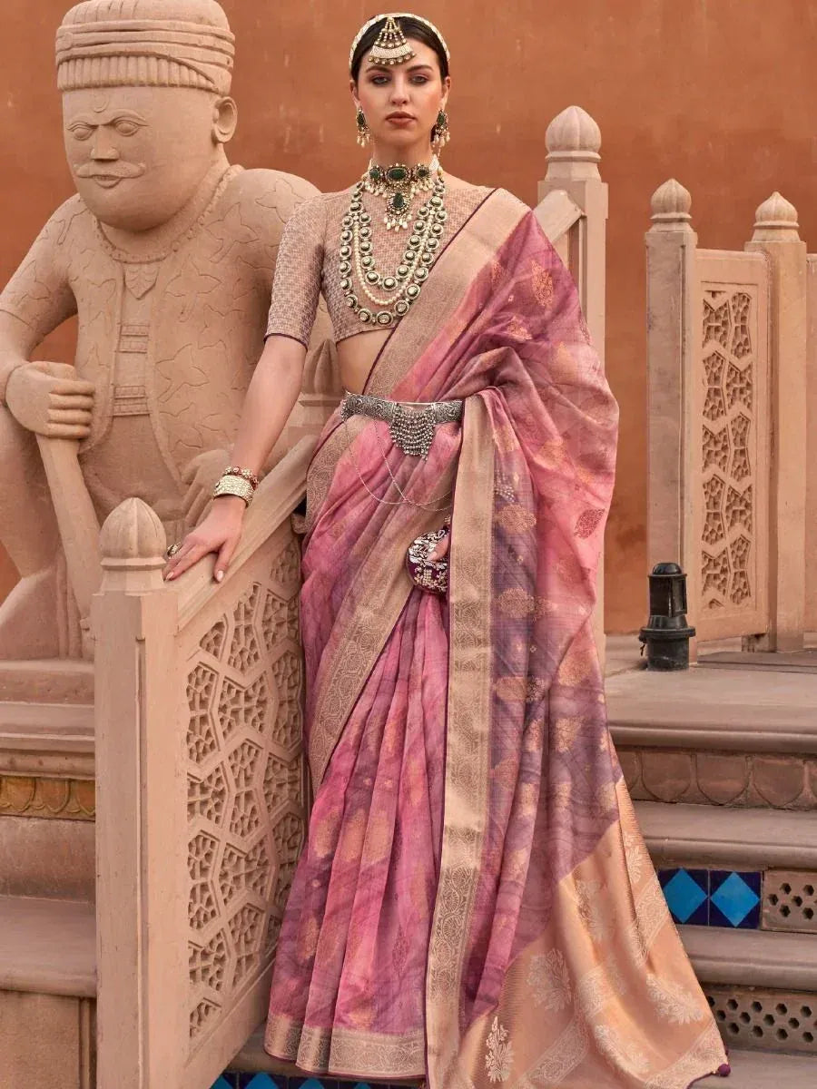 Woman in pink and gold designer saree with heavy jewelry, traditional Indian ethnic wear