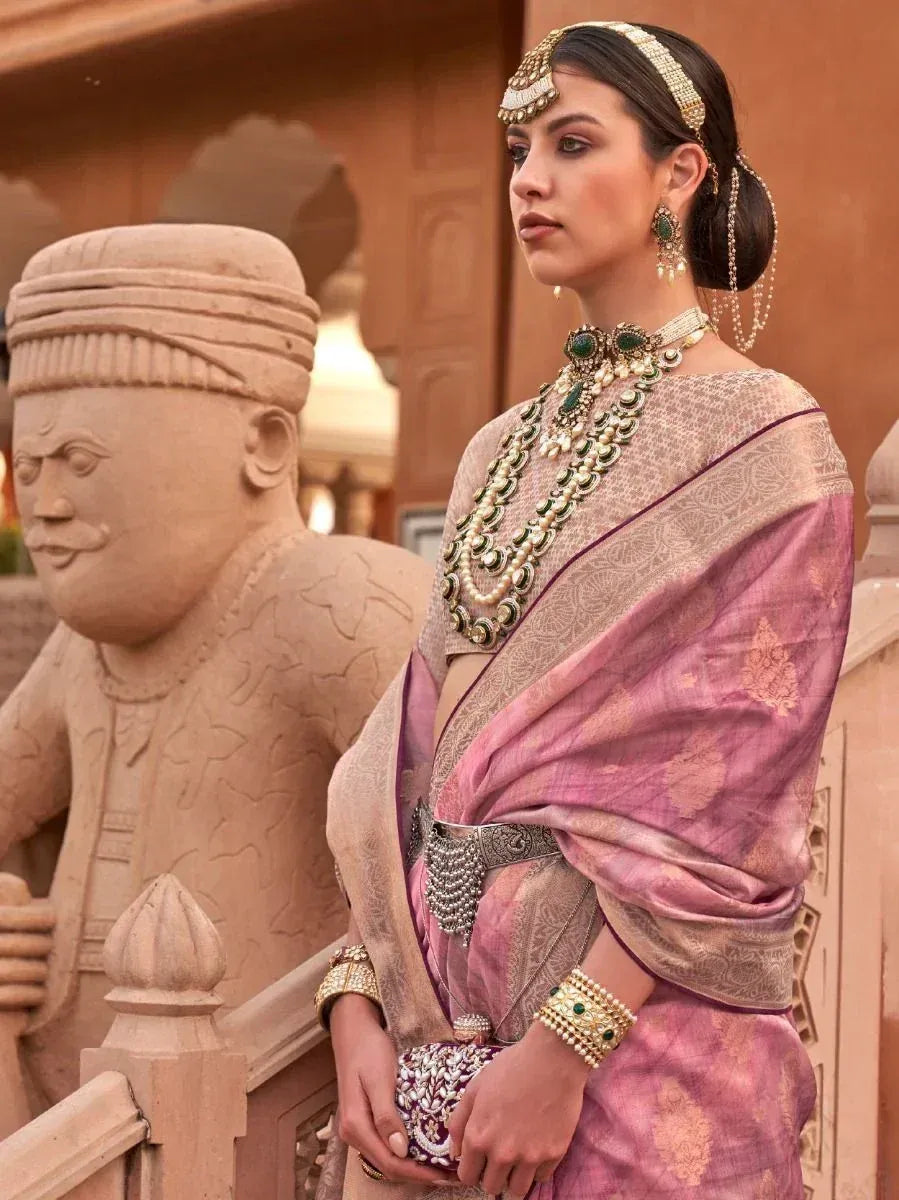 Elegant woman in pink designer saree with gold jewelry, traditional Indian ethnic wear