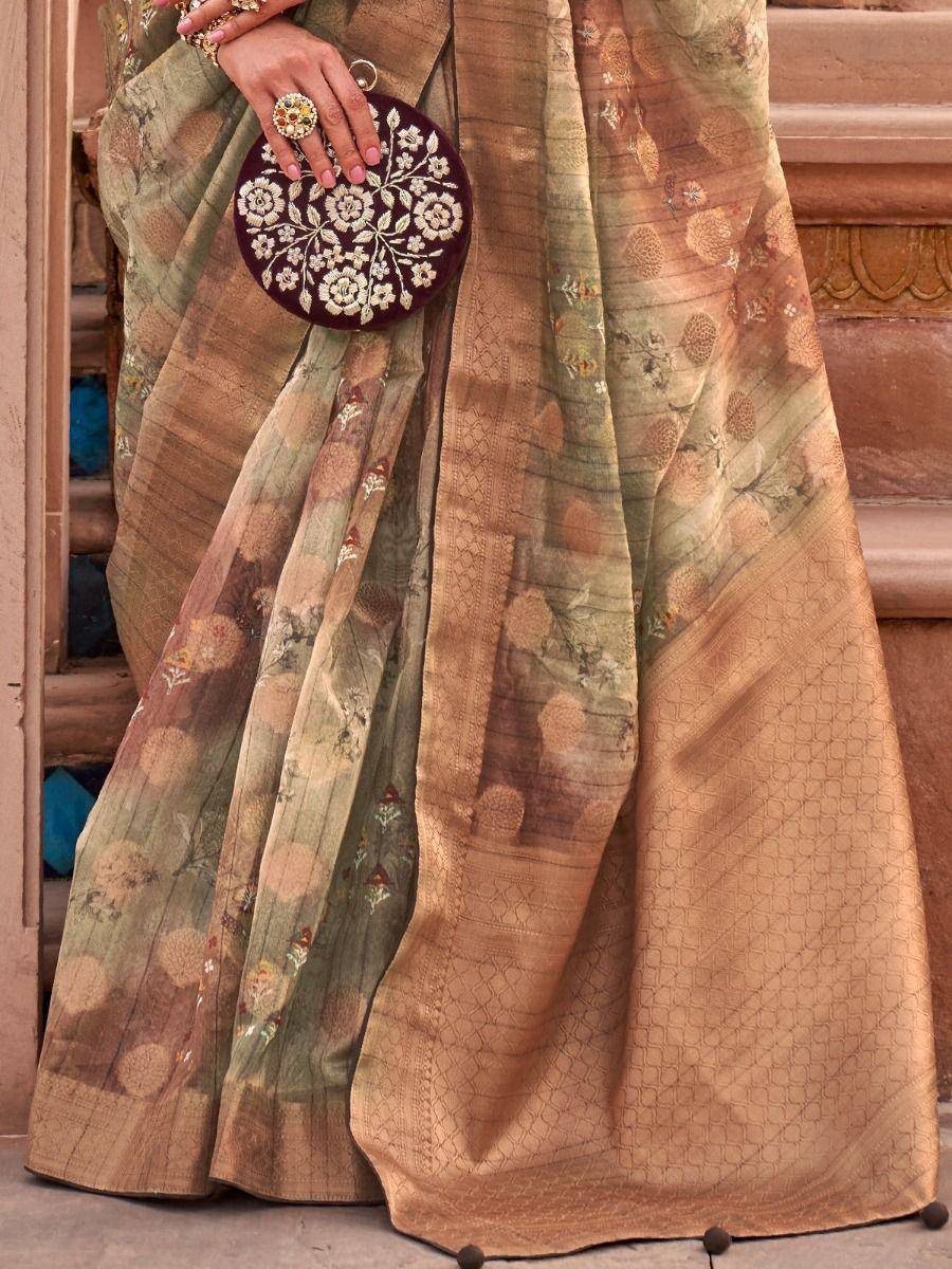 Elegant Indian saree with floral embroidery, paired with a matching embroidered clutch for ethnic wear.
