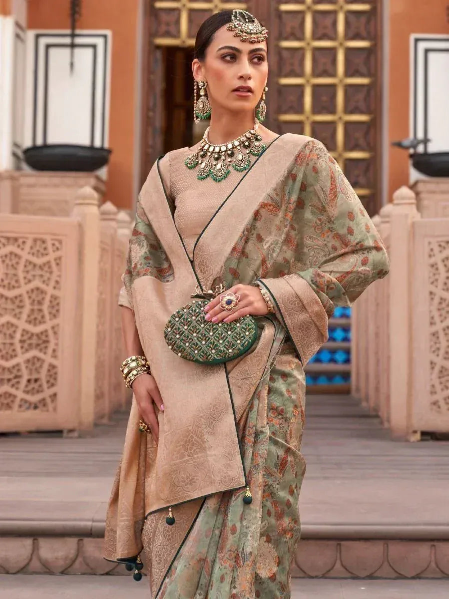 Woman in elegant green and beige printed saree with heavy jewelry, perfect for Indian ethnic occasions.